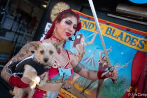 This is a picture of Wendy Blades, sword swallower, holding her dog.