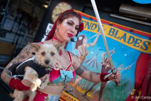 This is a picture of Wendy Blades, sword swallower, holding her dog.