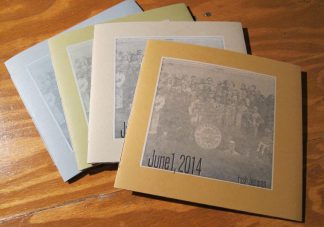 4 copies of Tosh Berman's book June 1, 2014, laying on a table